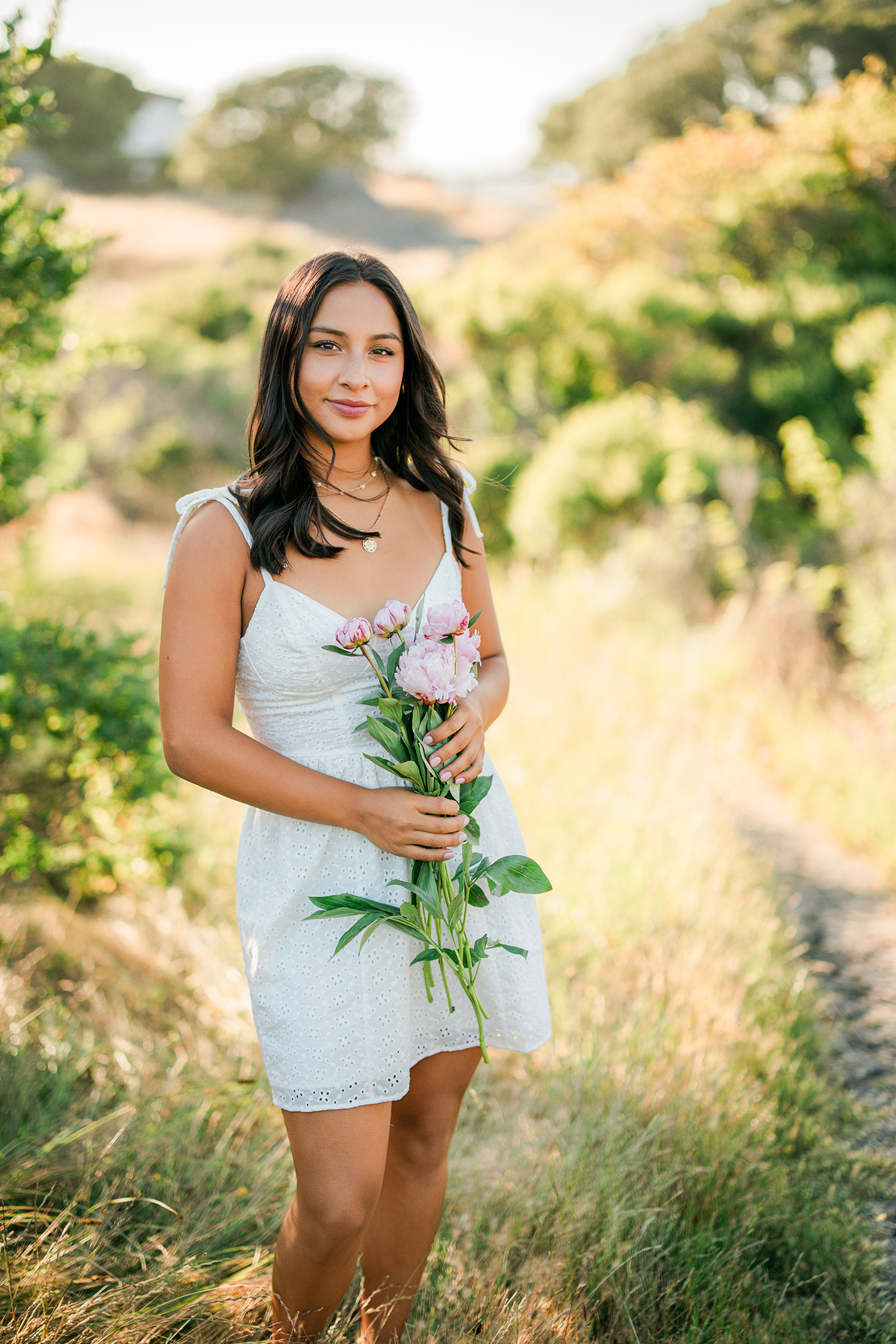 Branson School senior portrait holding flowers in Marin golden hills during summer session