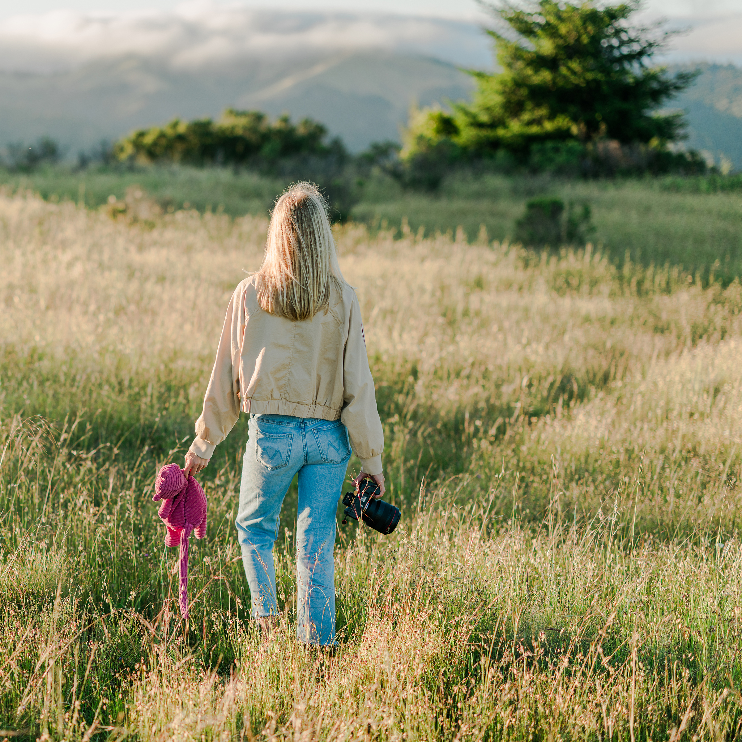 Senior photographer Leah Prahm holding Midge the Jellycat while scouting locations in Marin County