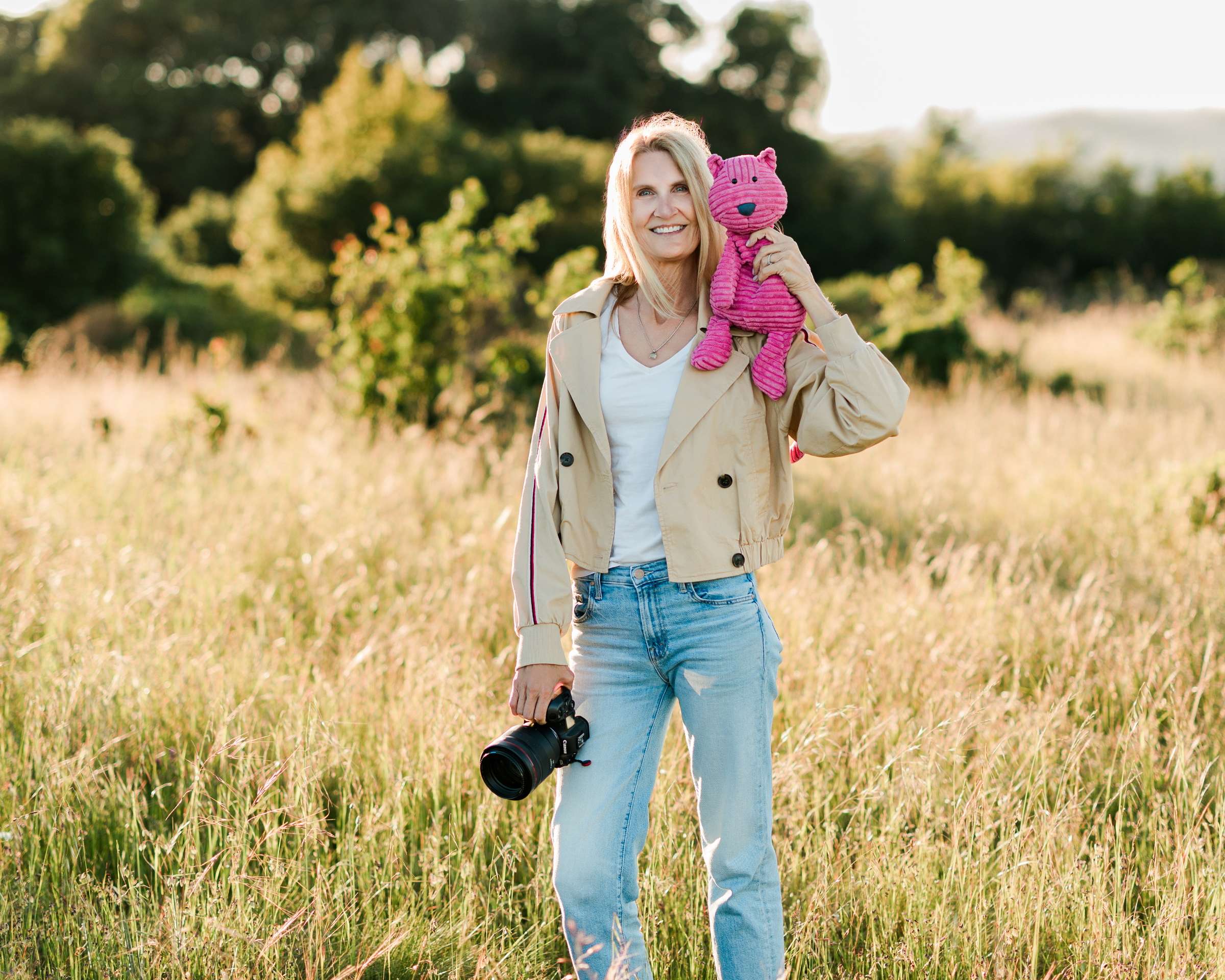 Marin County senior photographer Leah Prahm scouting portrait locations with Midge the Jellycat in a golden field at sunset