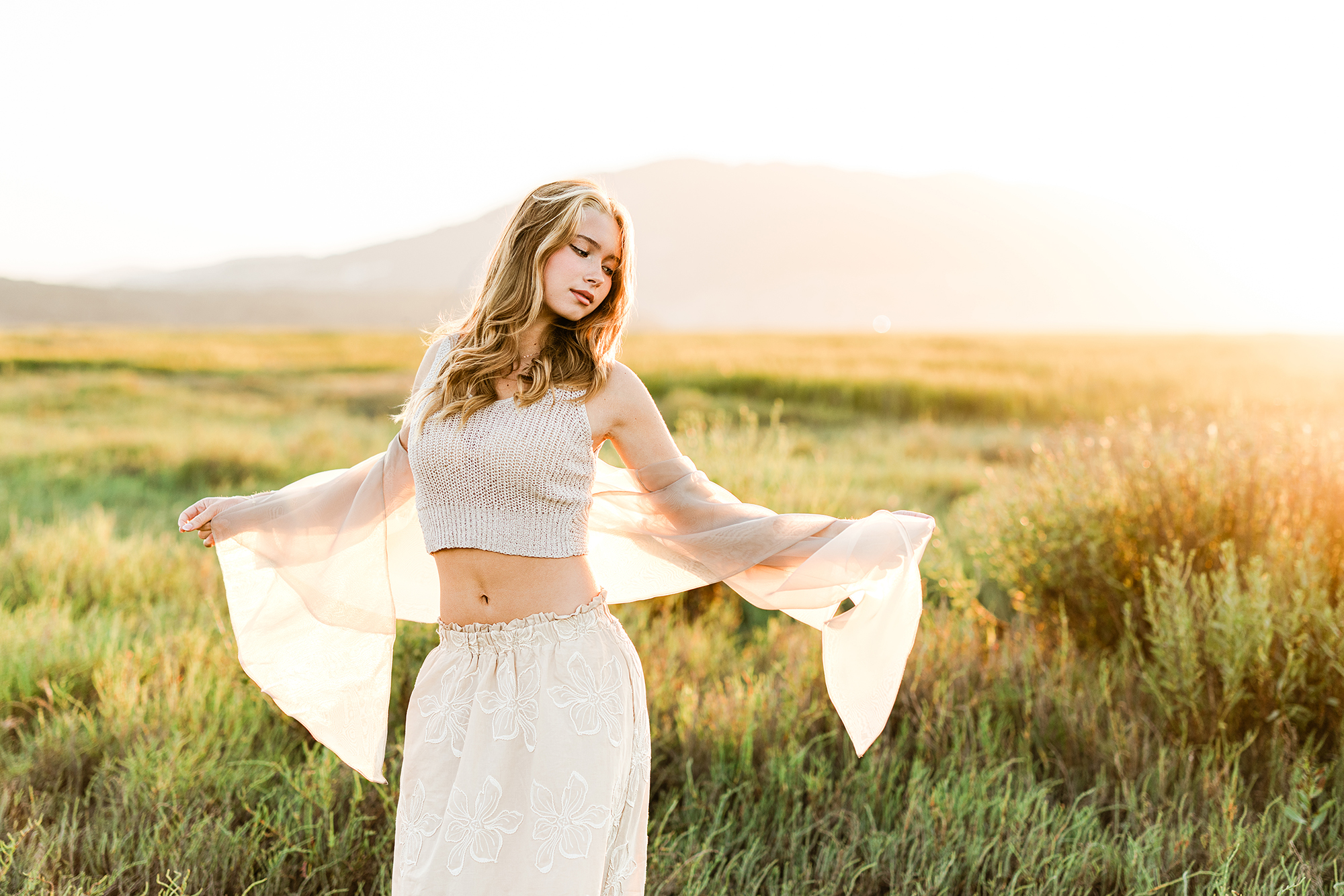 Rising senior Sofia looking over her shoulder during a golden-hour senior portrait session in a Marin County coastal marsh.